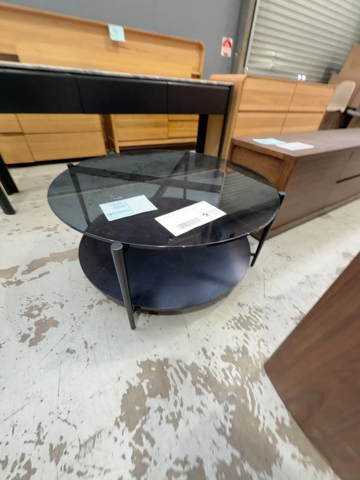 EX STAGING - BLACK GLASS ROUND COFFEE TABLE SOLD AS IS EX STAGING - BLACK GLASS ROUND COFFEE TABLE SOLD AS IS