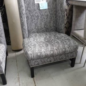 SECOND HAND FURNITURE - LARGE WINGBACK CHAIR SILVER & BLACK PAISELY MATERIAL SOLD AS IS