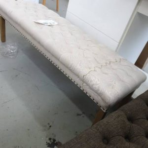 SECOND HAND FURNITURE - BEIGE BUTTON OTTOMAN SOLD AS IS LARGE STAIN