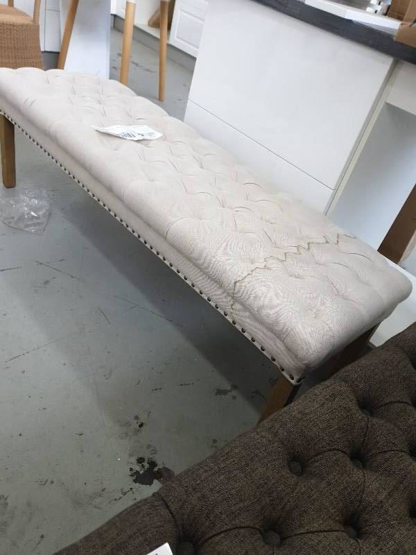 SECOND HAND FURNITURE - BEIGE BUTTON OTTOMAN SOLD AS IS LARGE STAIN