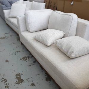EX FURNITURE HIRE - CREAM UPHOLSTERED COUCH WITH CHAISE SOLD AS IS