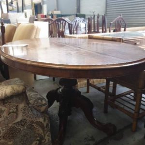 SECOND HAND FURNITURE - ORNATE OVAL TIMBER TABLE SOLD AS IS