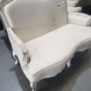 EX HIRE FURNITURE - FRENCH PROVINCIAL 2 SEATER CREAM COUCH CARVED TIMBER FRAME AND LEGS SOLD AS IS