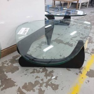 EX HIRE - ABSTRACT SHAPED GLASS TOP COFFEE TABLE WITH BLACK TIMBER LEGS (SOLD AS IS)