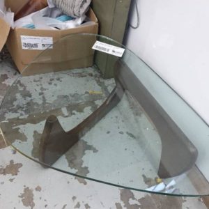 EX HIRE - ABSTRACT SHAPED GLASS TOP COFFEE TABLE WITH BROWN TIMBER LEGS (SOLD AS IS)