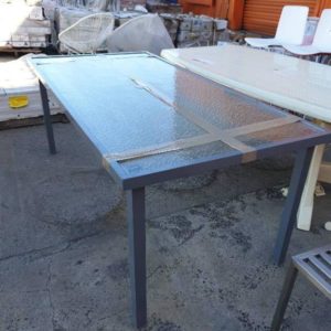 SECOND HAND - OUTDOOR GLASS TABLE SOLD AS IS