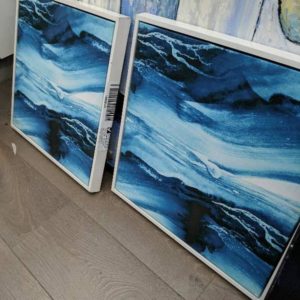 EX HIRE - PAIR OF BLUE ART WHITE FRAME EACH FRAME IS 500MM X 500MM WHITE FRAME HAS MINOR DAMAGE
