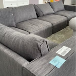 SECONDS - LARGE GREY SECTIONAL MATERIAL COUCH MATERIAL PILLED SOLD AS IS