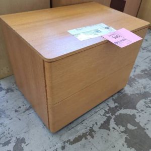 EX HIRE - LIGHT OAK CURVED BEDSIDE TABLE SOLD AS IS