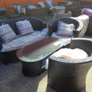 BLACK RATTAN OUTDOOR SETTING WITH COUCH ARM CHAIR AND COFFEE TABLE WITH GLASS TOP