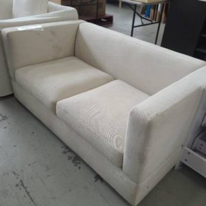 EX HIRE - CREAM 2 SEATER COUCH SOLD AS IS