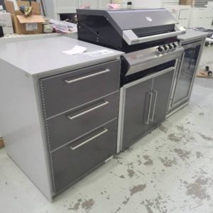 EX DISPLAY 2300MM OUTDOOR BBQ KITCHEN WITH ZIEGLER AND BROWN 4 BURNER BBQ WITH GASMATE SINGLE GLASS DOOR FRIDGE WITH 3 DRAWER MODULE GREY STONE TOP WITH SINGLE WATERFALL OTHER SIDE TO BE AGAINST WALL WITH BLACK CABINETRY. WITH 3 MONTH WARRANTY