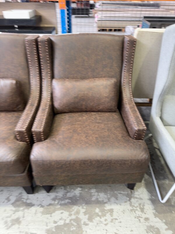 EX HIRE BROWN UPHOLSTERED HIGH BACK ARMCHAIR WITH STUD DETAIL, SOLD AS IS