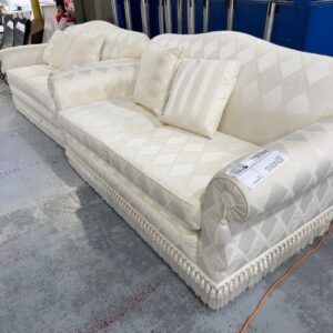 SECONDHAND - CUSTOM MADE ANTIQUE WHITE 2 SEATER COUCH, FRINGE DETAIL, SMALL RUN IN FABRIC ON LEFT SIDE ARM, SOLD AS IS