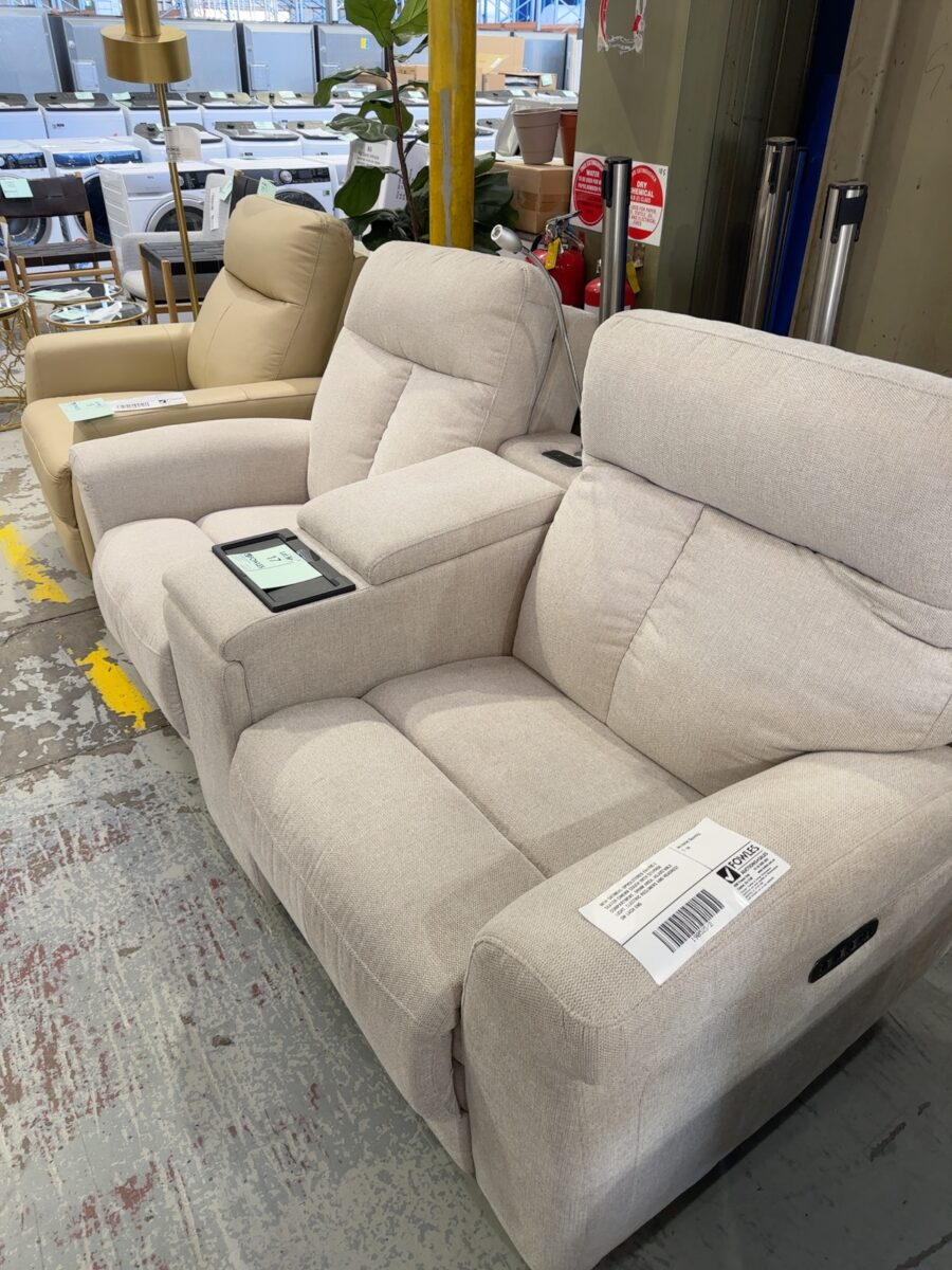 NEW OATMEAL UPHOLSTERED FABRIC 2 SEATER CINEMA COUCH WITH STORAGE COMPARTMENT, DRINK AREA, ADJUSTABLE LIGHT, ELECTRIC RECLINERS AND HEADREST ON EACH END