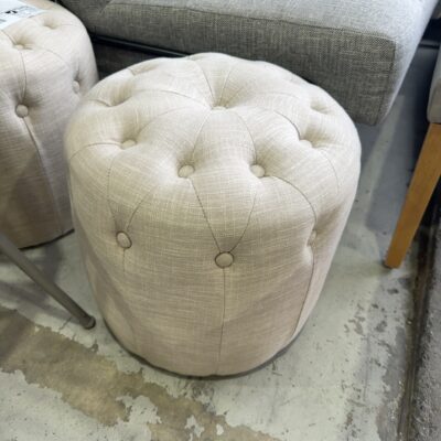 EX STAGING FURNITURE - BEIGE ROUND OTTOMAN, SOLD AS IS