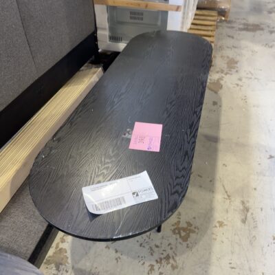 EX STAGING FURNITURE - OVAL BLACK TIMBER COFFEE TABLE, SOLD AS IS