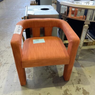 EX STAGING FURNITURE - ORANGE MATERIAL UPHOLSTERED CHAIR, SOLD AS IS