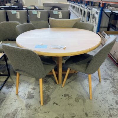EX STAGING FURNITURE - ROUND TIMBER 1200MM DINING TABLE WITH 4 GREY UPHOLSTERED CHAIRS, SOLD AS IS
