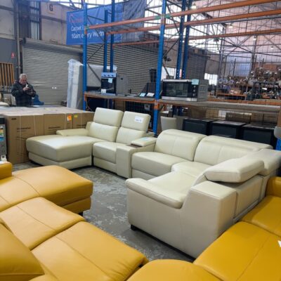NEW CUSTOM MADE CREAM LEATHER MODULAR CORNER COUCH WITH CHAISE, ELECTRIC RECLINER WITH CONCEALED BUTTONS, CONCEALED DRINK HOLDERS WITH STORAGE COMPARTMENT, SOLD AS IS