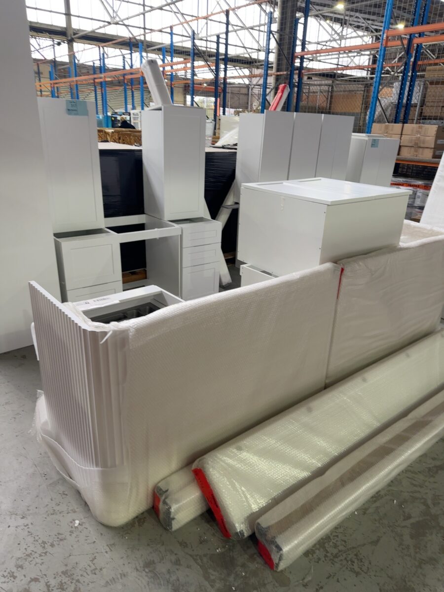 SAMPLE KITCHEN - NEW WHITE SATIN 2 PAC KITCHEN CABINETS WITH HAMPTON SQUARE DOORS, WITH LARGE CURVED FLUTED ISLAND BACK, WITH CHROME PULL OUT PANTRY SOLD AS IS