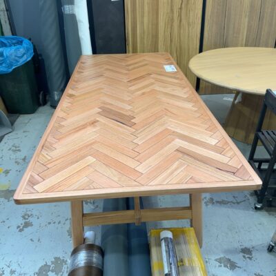 NEW BALLY 2400MM MESSMATE NATURAL HERRINGBONE DINING TABLE, CURVED EDGES SOLD AS IS