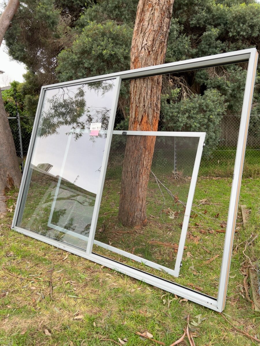 2400X3300 EX DISPLAY EXTREMLEY HEAVY ALUMINIUM SLIDING DOOR UNIT WITH FLYSCREEN- (PLEASE NOTE THAT THE BUYER MUST BRING ENOUGH PEOPLE TO PICK UP THIS ITEM AS IT IS VERY HEAVY)