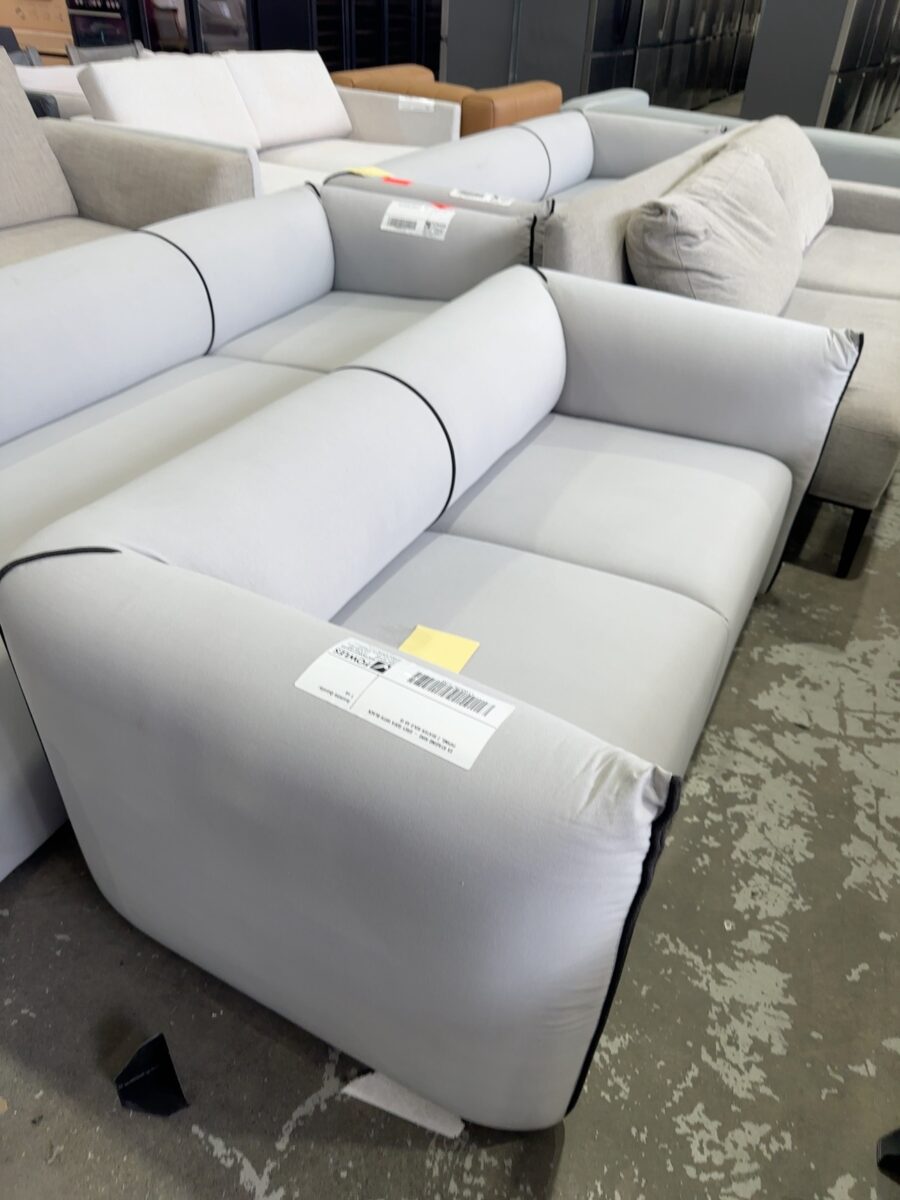 EX STAGING HIRE - GREY SOFA WITH BLACK PIPING, 2 SEATER SOLD AS IS