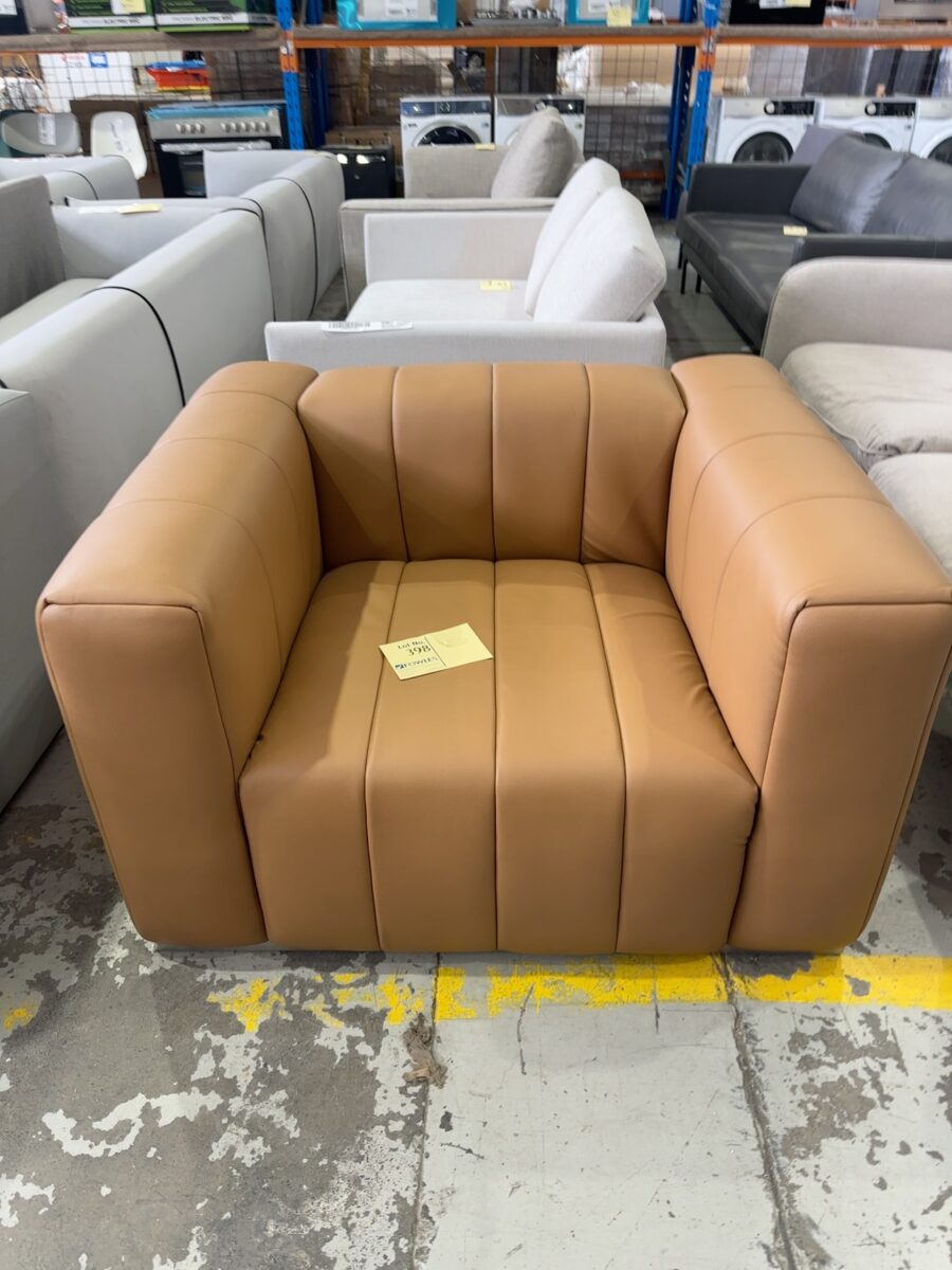 EX STAGING HIRE - TAN VINYL ARMCHAIR SOLD AS IS
