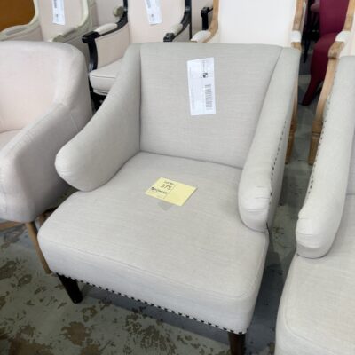 EX STAGING HIRE - BEIGE MATERIAL ARMCHAIR WITH STUD DETAIL, SOLD AS IS