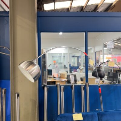 EX STAGING - LARGE CURVED SILVER METAL FLOOR LAMP, SOLD AS IS