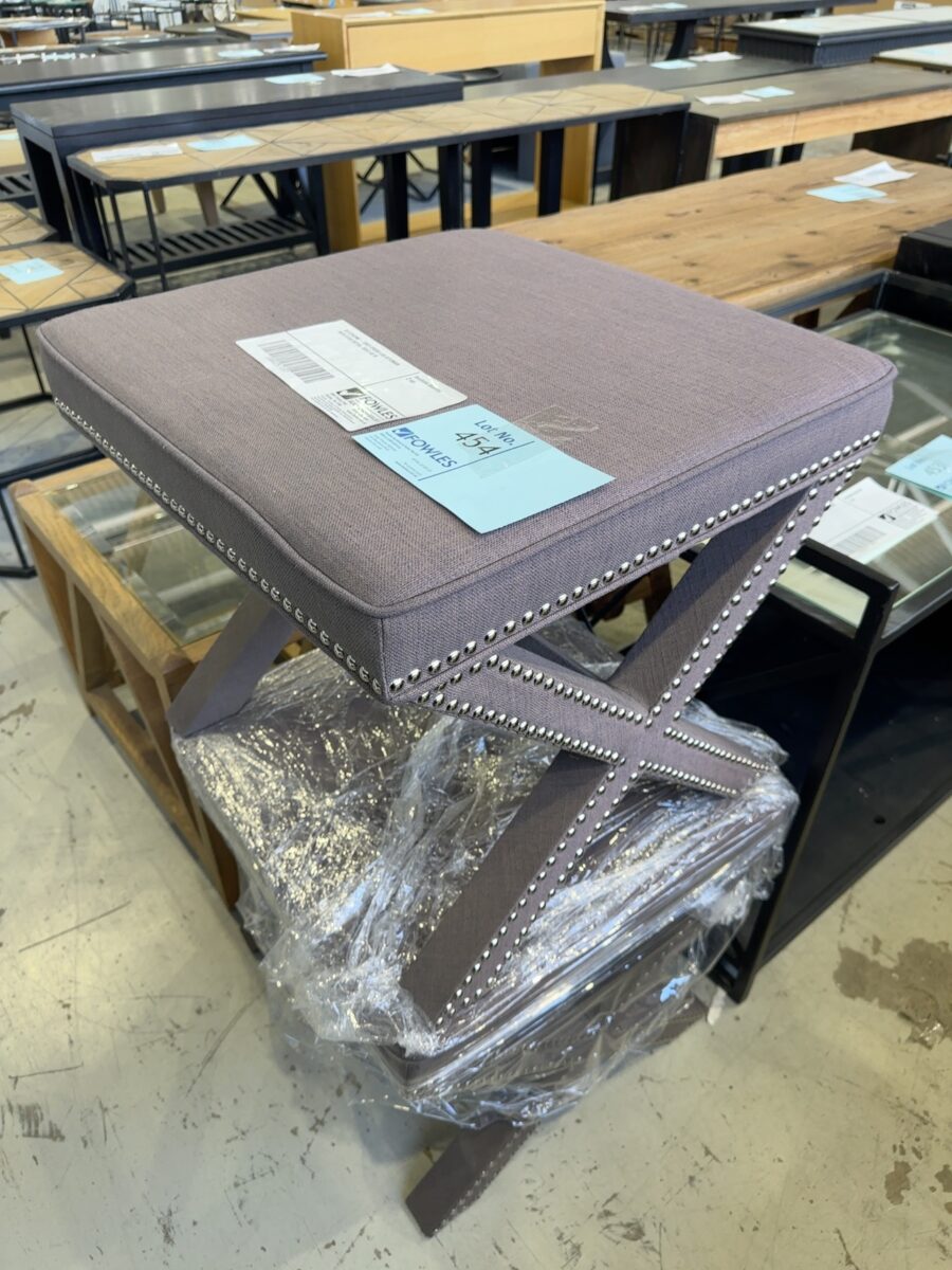 EX STAGING - GREY CROSS LEG OTTOMAN WITH STUD DETAIL, SOLD AS IS