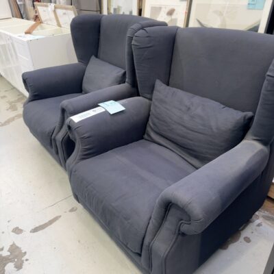 EX STAGING - LARGE BLACK MATERIAL WING BACK CHAIR, TIMBER LEGS, SOLD AS IS