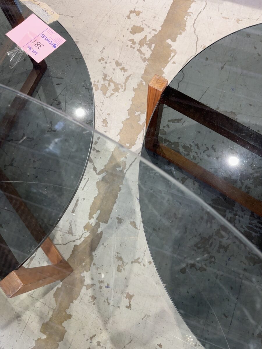 EX STAGING - 1500MM ROUND GLASS TABLE, WITH TIMBER CROSS LEG BASE, CHIPPED EDGE ON GLASS