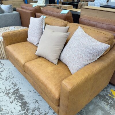 FURNITURE RETAILER CLOSURE - LUXE SOFAS 2 SEATER TAN LEATHER COUCH, WITH 4 CUSHIONS, RRP$2599 SOLD AS IS FURNITURE RETAILER CLOSURE - LUXE SOFAS 2 SEATER TAN LEATHER COUCH, WITH 4 CUSHIONS, RRP$2599 SOLD AS IS