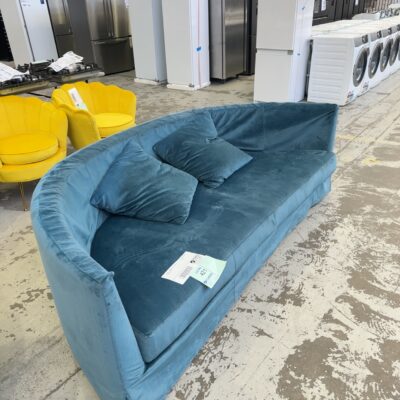 EX HIRE - LARGE CURVED TEAL VELVET COUCH, SOLD AS IS