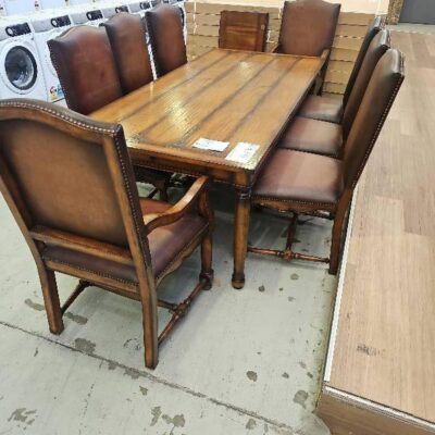 SECOND HAND - TIMBER DINING TABLE AND EIGHT CHAIRS SOLD AS IS