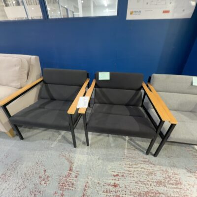 EX STAGING - BLACK ARMCHAIR WITH TIMBER ARMS, SOLD AS IS