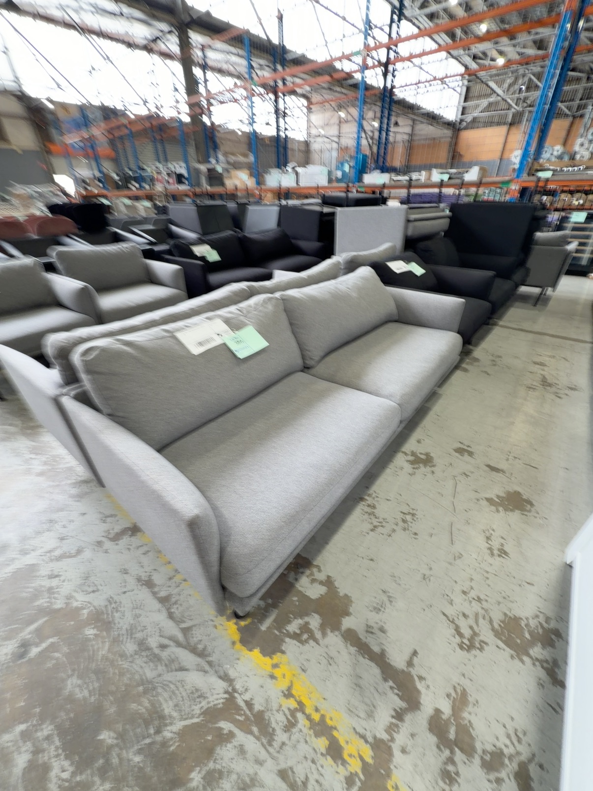 EX HIRE - GREY MATERIAL COUCH, SOLD AS IS EX HIRE - GREY MATERIAL COUCH, SOLD AS IS