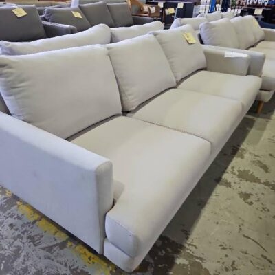 EX STAGING BEIGE FABRIC COUCH, 3 SEATER SOLD AS IS