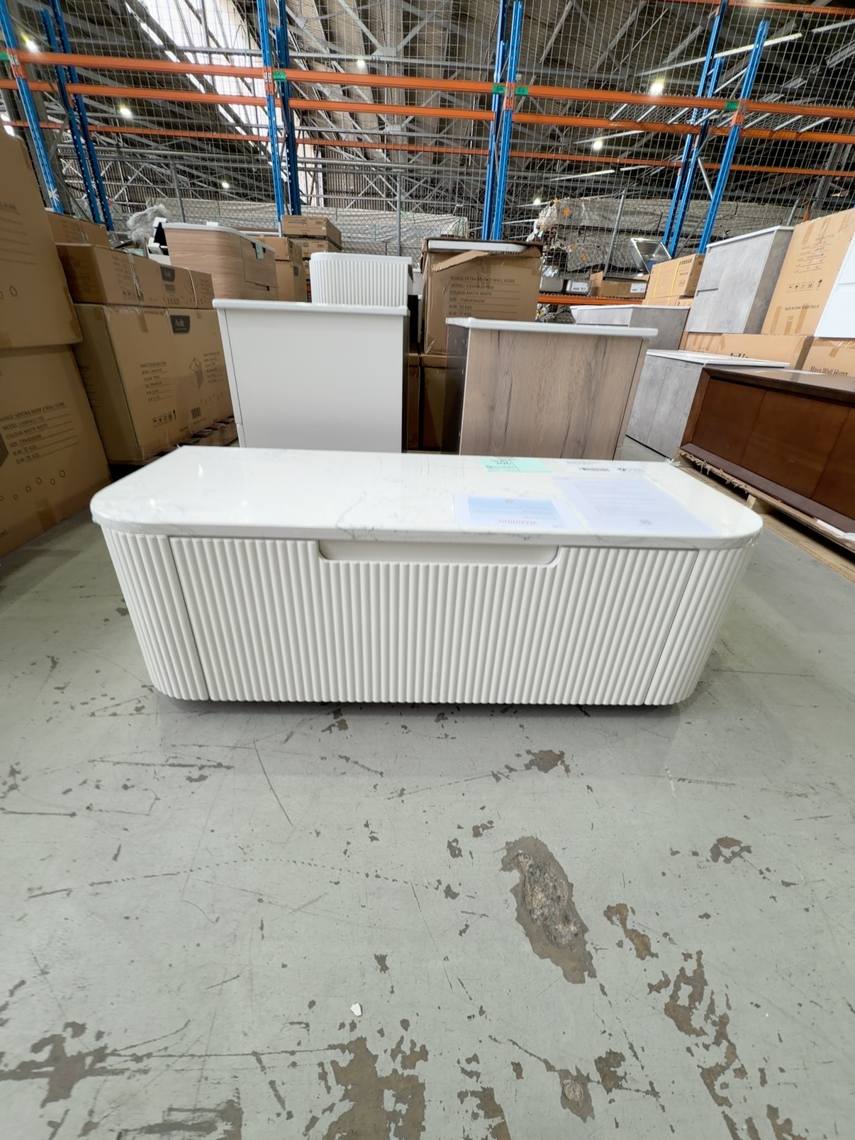 NEW AULIC PETRA MARK II 1200MM WALL HUNG VANITY, CURVED MATTE WHITE V GROOVE PROFILE, SINGLE DRAWER, WITH CATO FLAT STONE TOP RRP$2409 CAWH46-1200-ST26FT NEW AULIC PETRA MARK II 1200MM WALL HUNG VANITY, CURVED MATTE WHITE V GROOVE PROFILE, SINGLE DRAWER, WITH CATO FLAT STONE TOP RRP$2409 CAWH46-1200-ST26FT