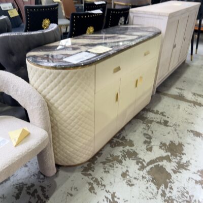 EX SHOWROOM - CREAM 1500MM PU BUFFET WITH QUILTED SIDES, AND CURVED STONE TOP SOLD AS IS
