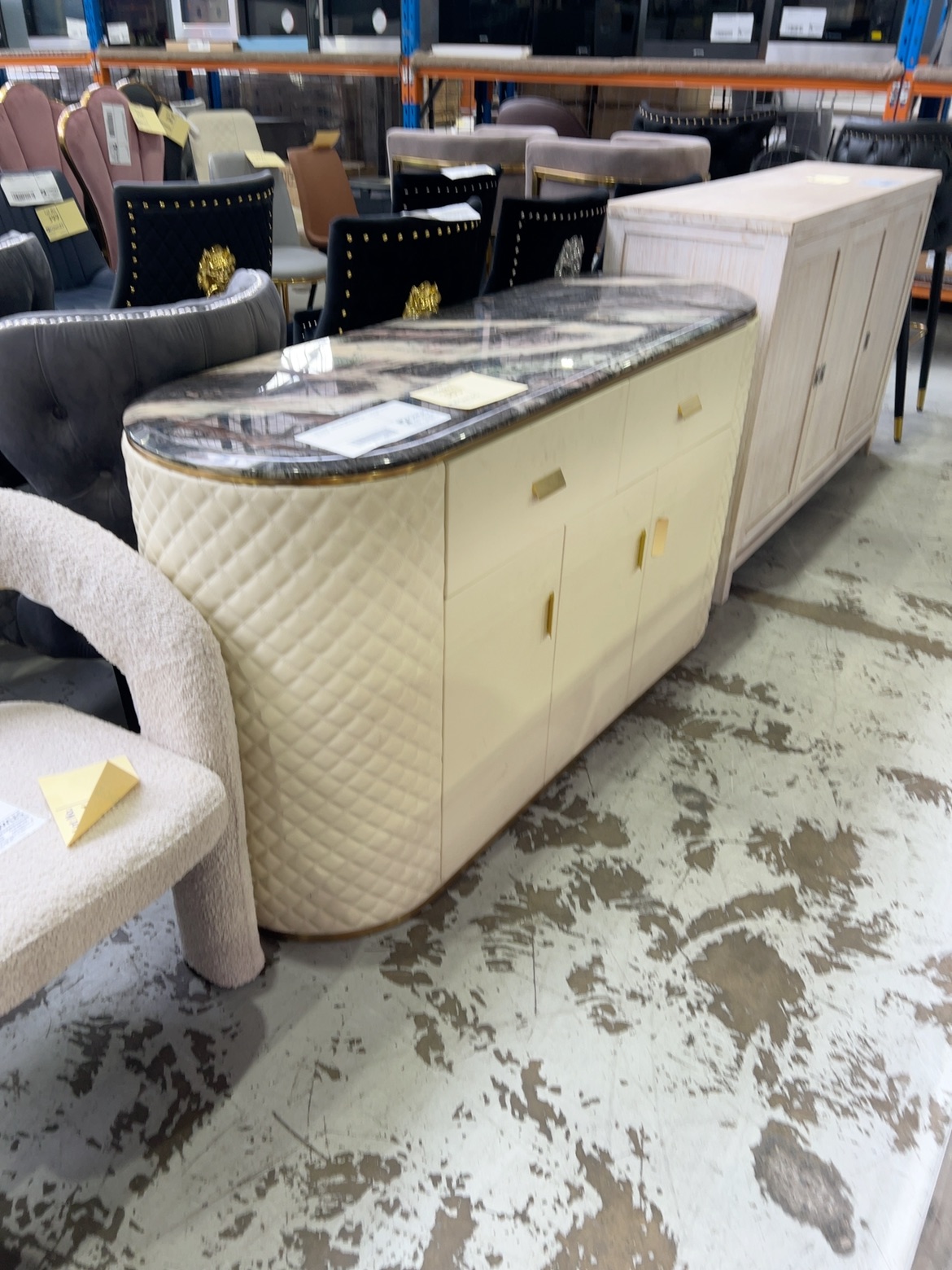 EX SHOWROOM - CREAM 1500MM PU BUFFET WITH QUILTED SIDES, AND CURVED STONE TOP SOLD AS IS EX SHOWROOM - CREAM 1500MM PU BUFFET WITH QUILTED SIDES, AND CURVED STONE TOP SOLD AS IS