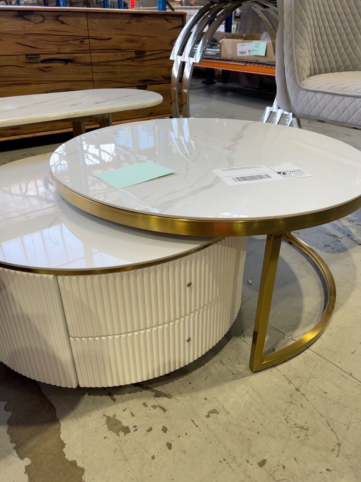 EX-SHOWROOM MILANO ROUND COFFEE TABLE WITH SLEEK STORAGE BASE, SOLD AS IS EX-SHOWROOM MILANO ROUND COFFEE TABLE WITH SLEEK STORAGE BASE, SOLD AS IS