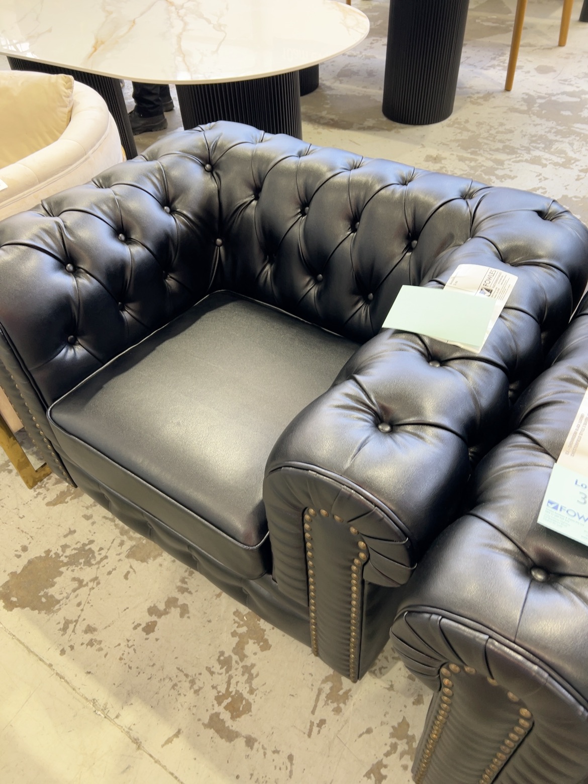 EX-SHOWROOM BLACK LEATHER CHESTERFIELD STYLE ARMCHAIR SOLD AS IS EX-SHOWROOM BLACK LEATHER CHESTERFIELD STYLE ARMCHAIR SOLD AS IS