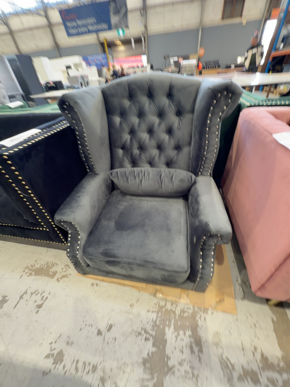 NEW LUXE DARK GREY VELVET WINGBACK ARMCHAIR WITH STUD DETAIL (NO LEGS PROVIDED, SOLD AS IS) NEW LUXE DARK GREY VELVET WINGBACK ARMCHAIR WITH STUD DETAIL (NO LEGS PROVIDED, SOLD AS IS)